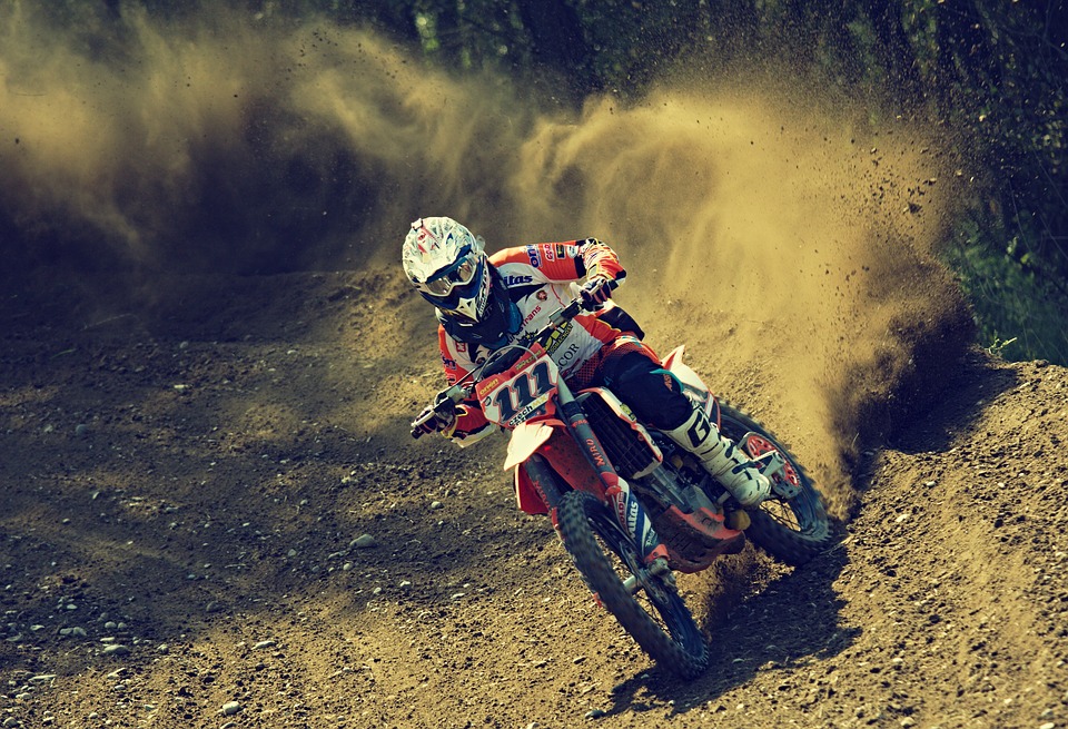 A rider riding a motocross bike - Motor Sport