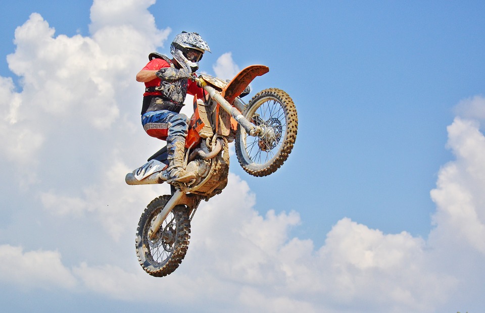 A rider jumping with a dirt bike